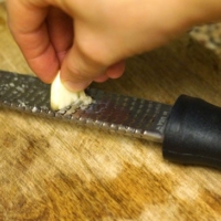 grating garlic on micro plane