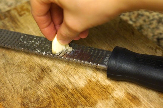 mincing garlic with a microplane