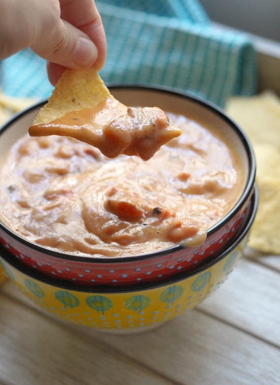 chip dipped in sweet potato queso dip