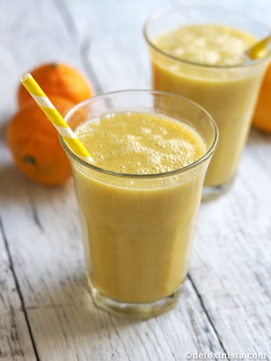 healthy orange julius shake in a glass with a straw