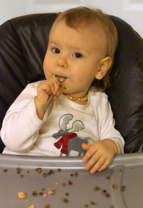 toddler with a spoon in his mouth