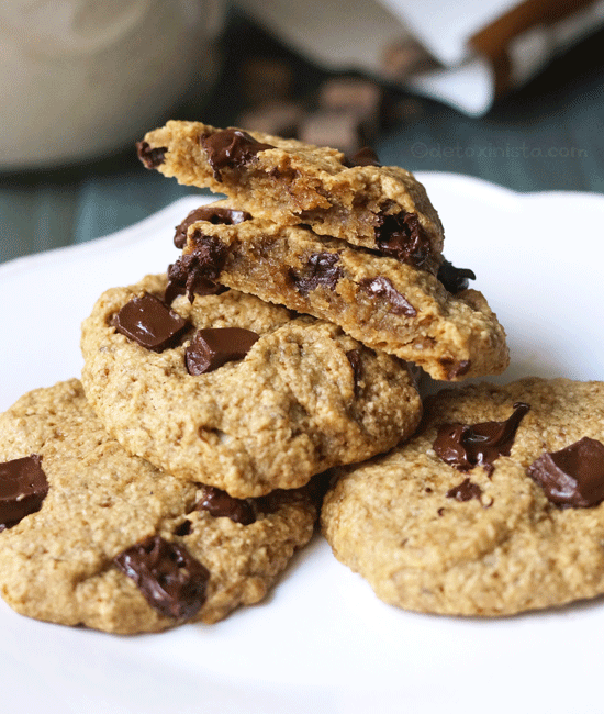 vegan and gluten-free chocolate chip cookies on a plate with the top cookie broken in half