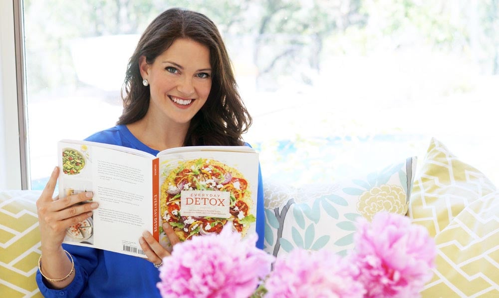 Megan holding everyday detox cookbook