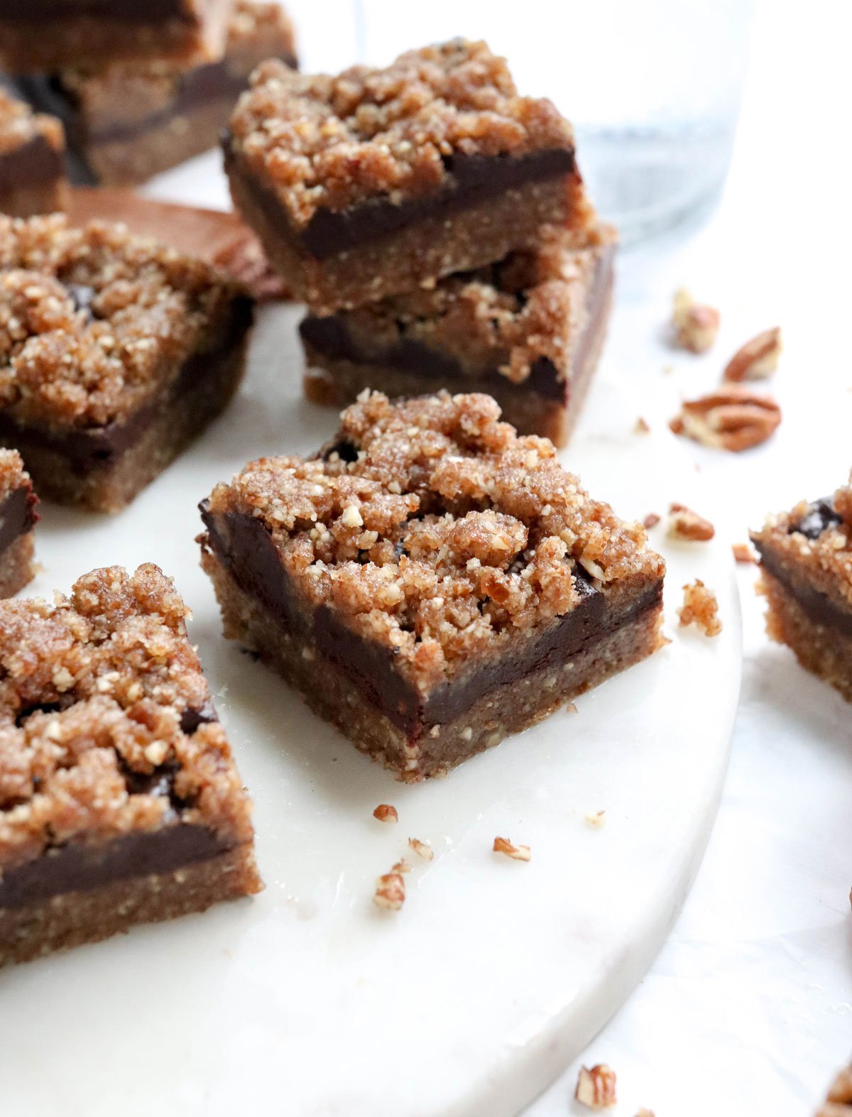 chocolate pecan pie bars on marble board