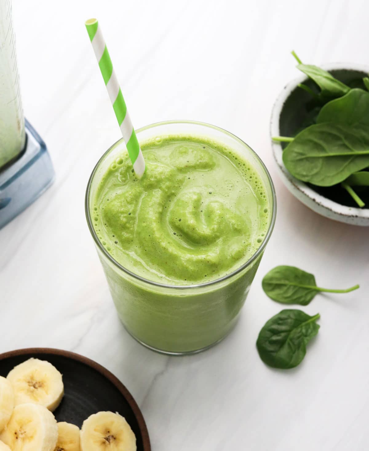 spinach smoothie with green striped straw