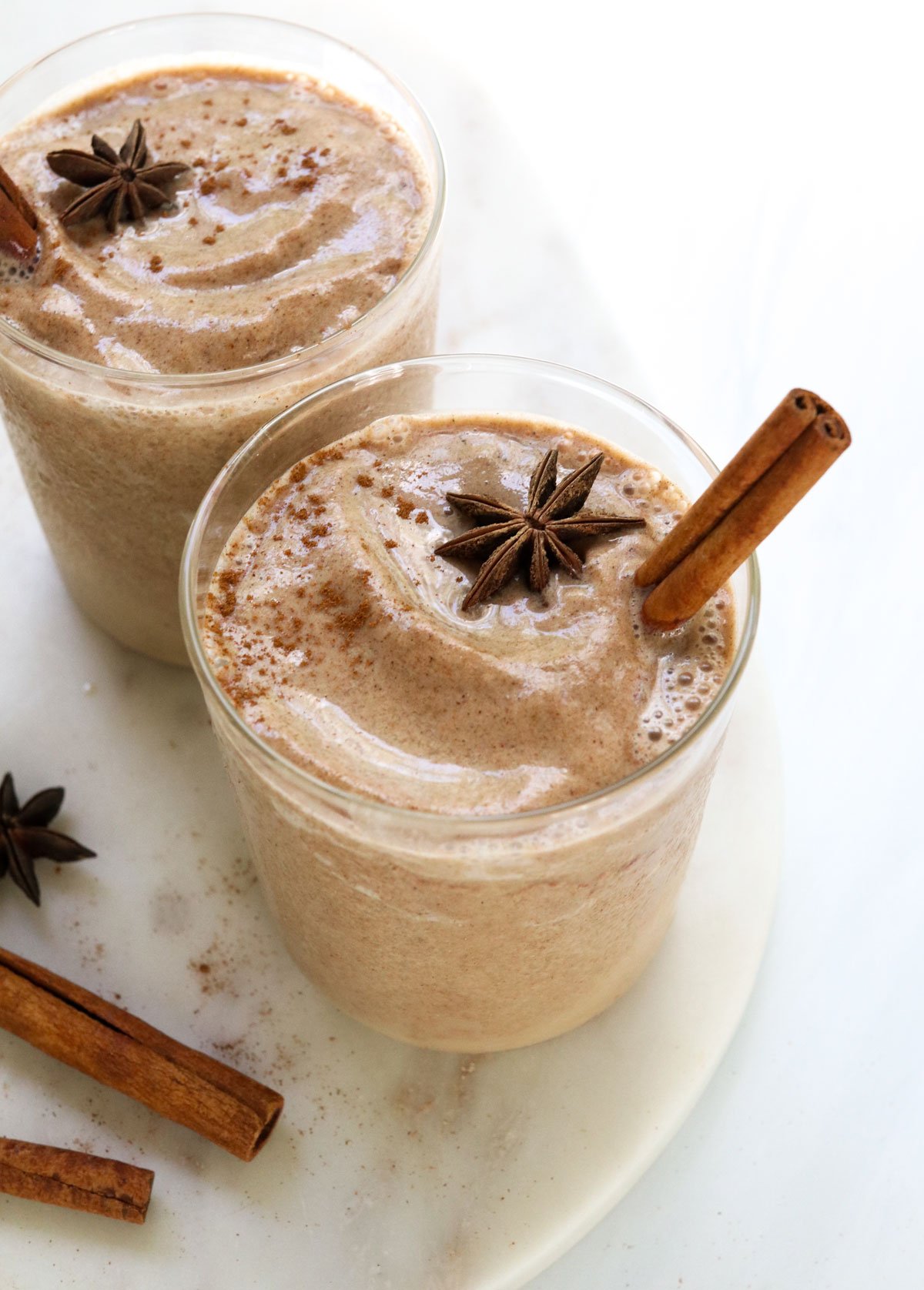 chai smoothies with cinnamon and star anise on top.