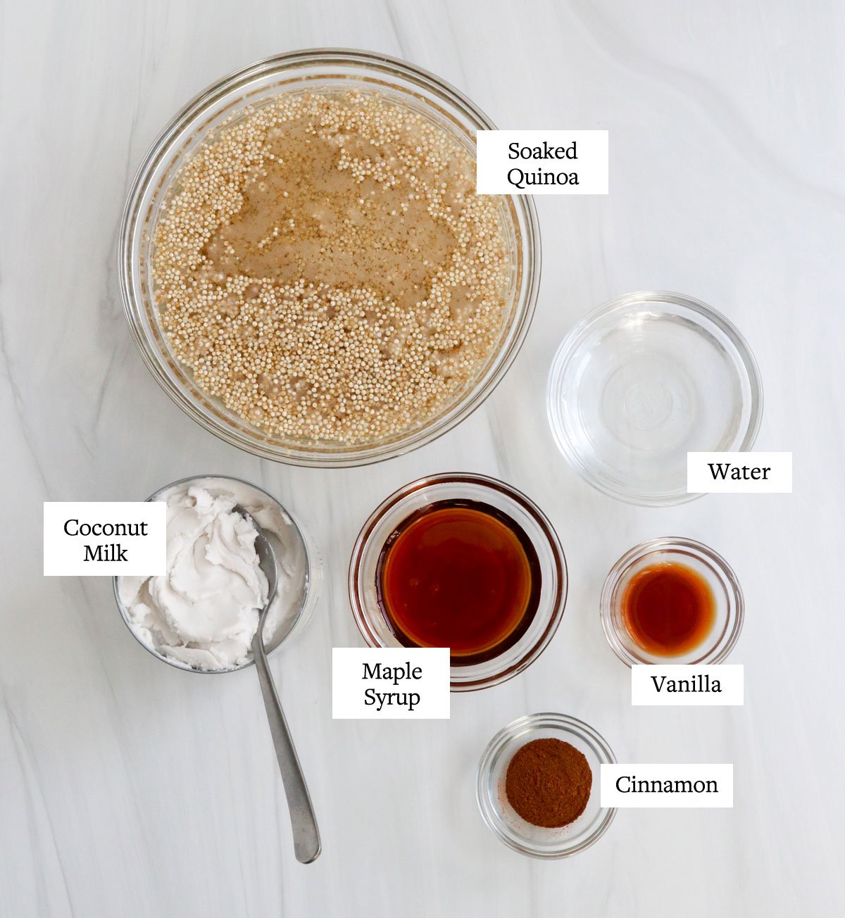 quinoa porridge ingredients labeled in glass bowls.