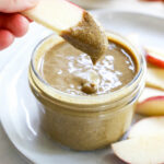 apple slice dipped into sunflower seed butter.