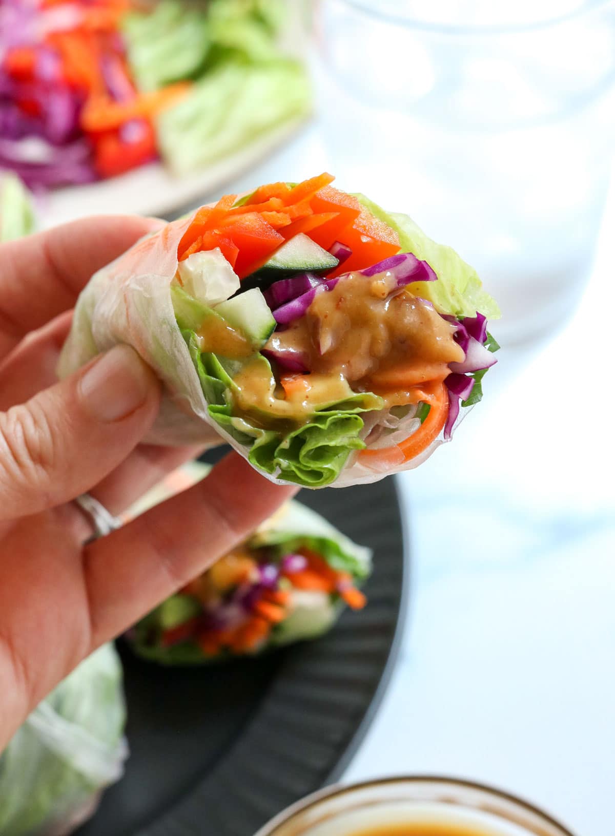 spring roll half dipped in peanut sauce