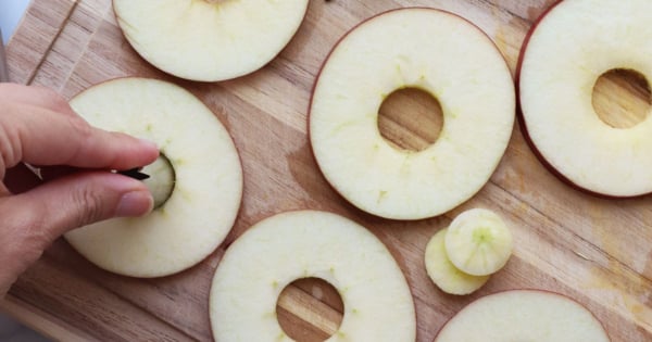 apples sliced into circles with holes removed from center.