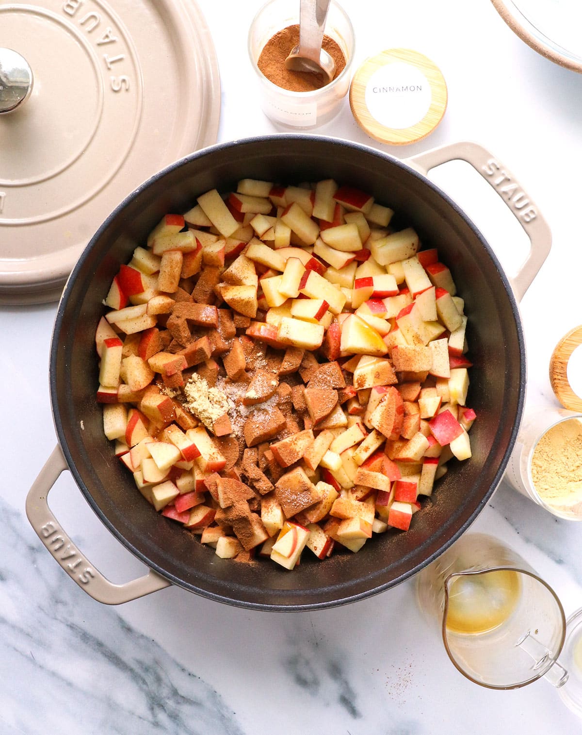 apples in a 4-quart pot with cinnamon and salt on top.