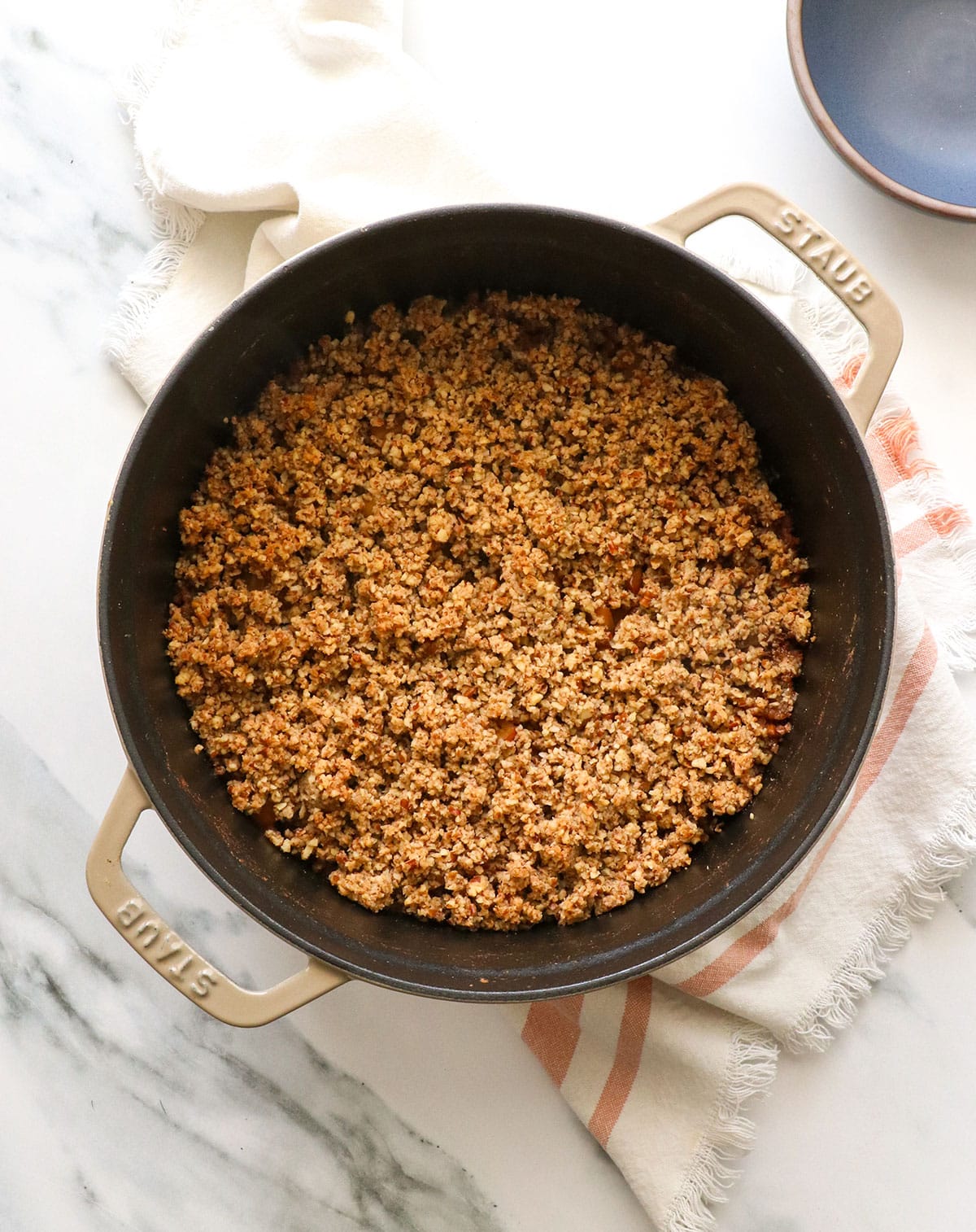 paleo apple crisp after baking in a dutch oven.