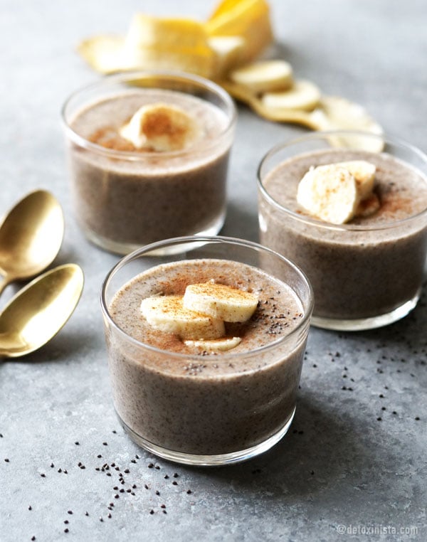 three glass bowls with chai spiced chia pudding with bananas on top