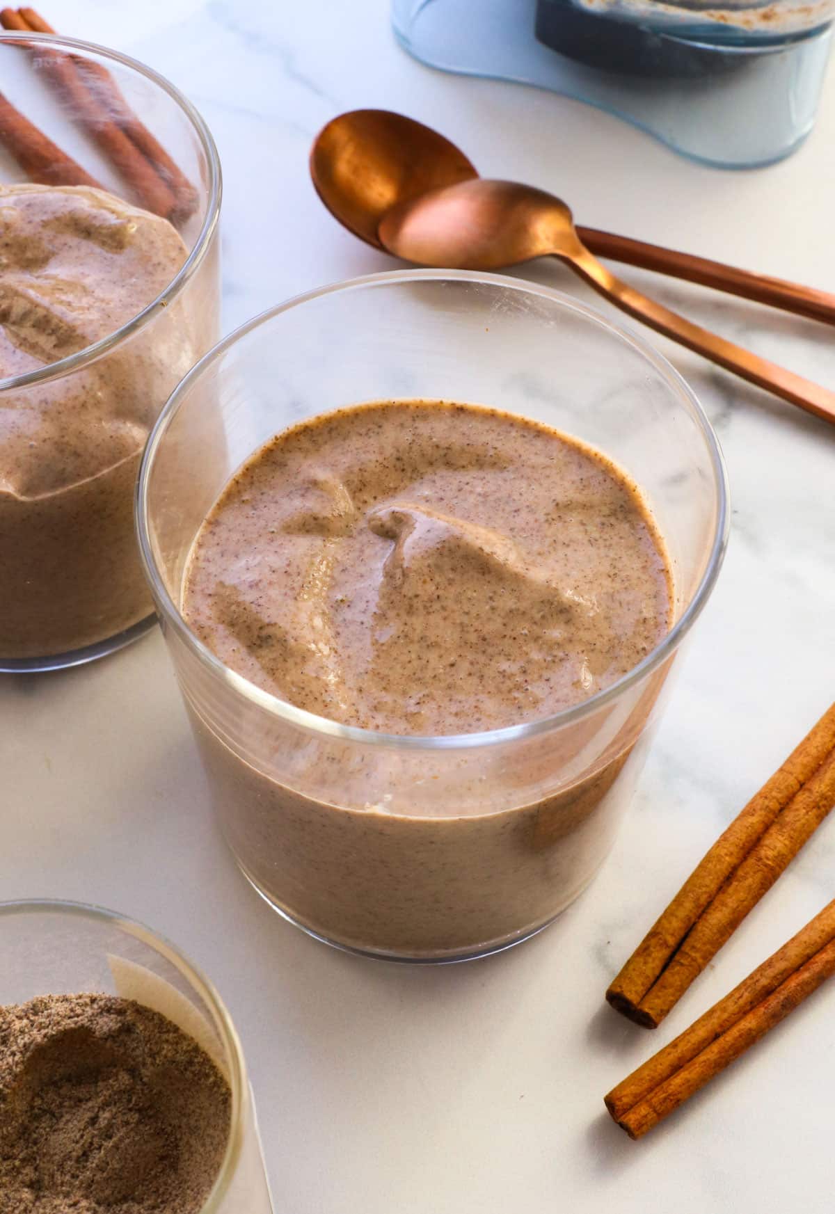 blended chia pudding served in two glasses with spoons.