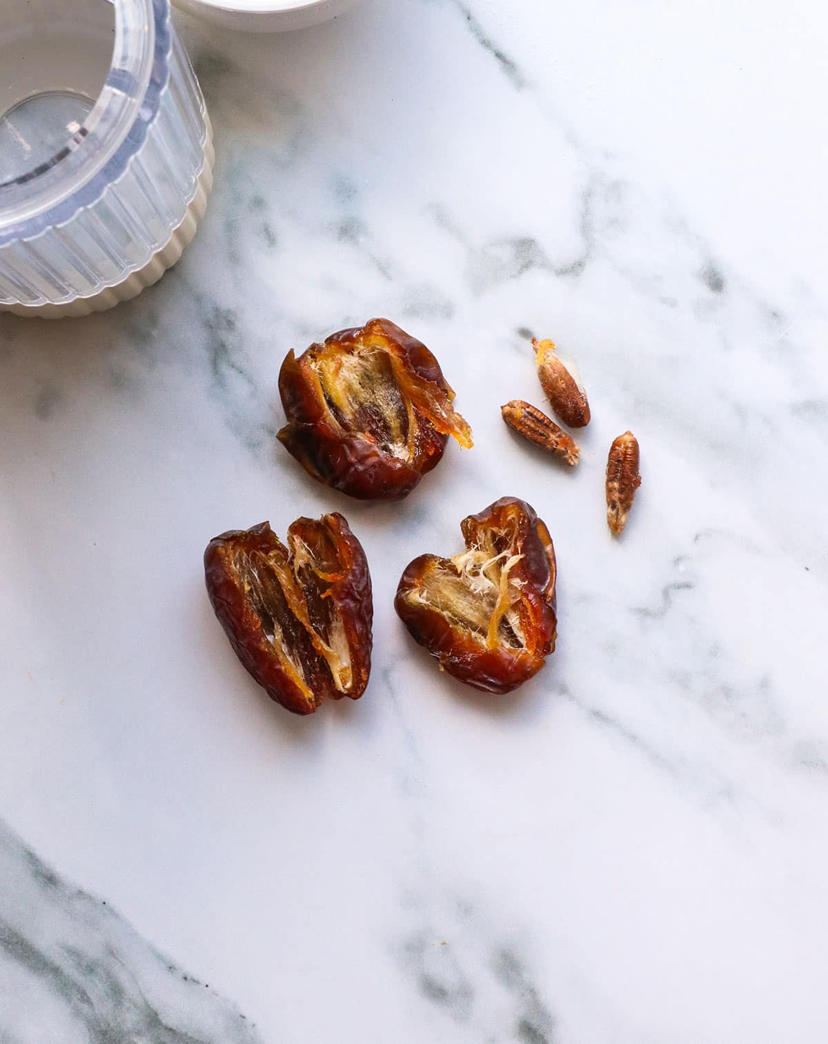 3 medjool dates split in half with the pits removed.