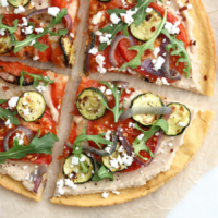 socca pizza with vegetables on top