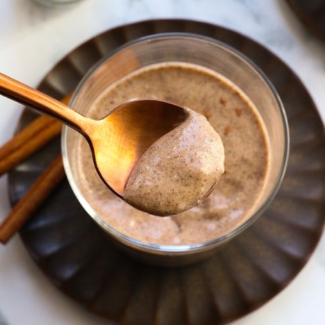 chai chia pudding served on a gold spoon.