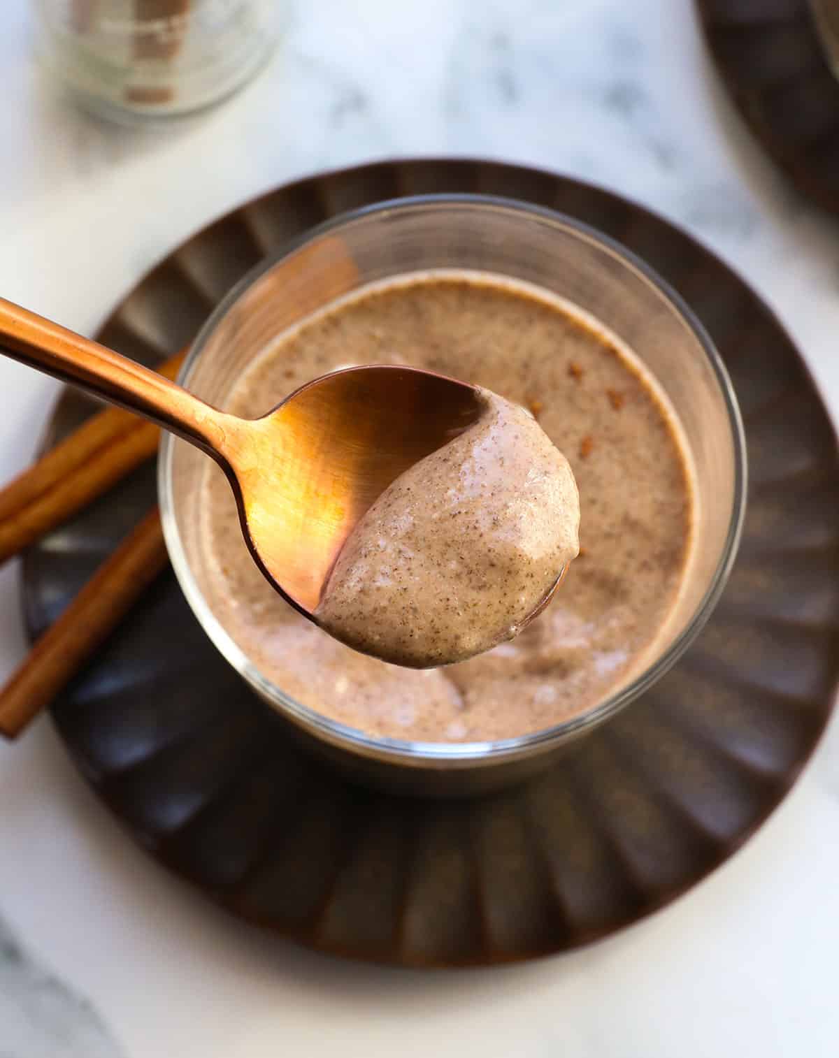chai chia pudding served on a gold spoon.