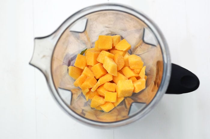blender with mango chunks in it