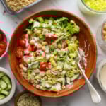 vegan lunch bowl eaten with a fork and tossed in a creamy tahini dressing.