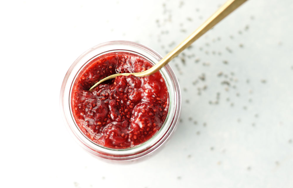 jar of strawberry chia jam with a spoon