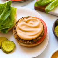 vegan burger sauce spread on a veggie patty and bun.