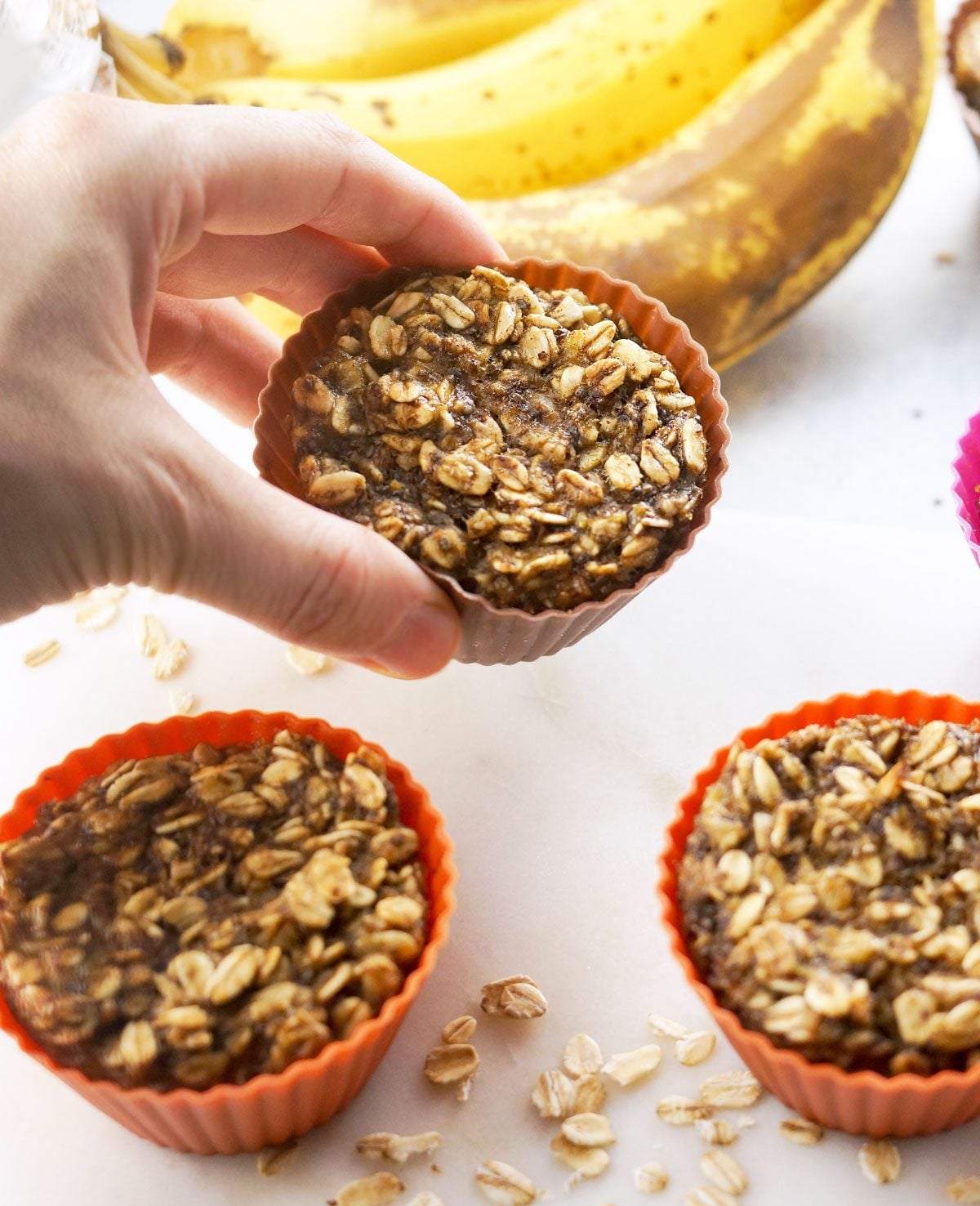 hand holding a baked banana oatmeal cup