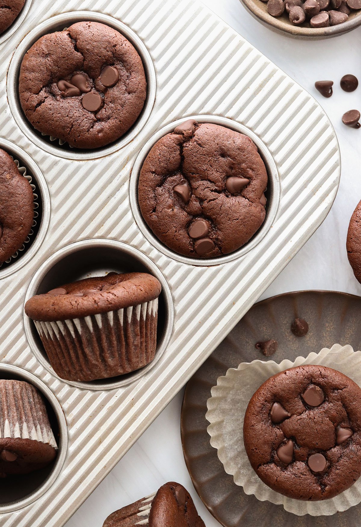 chocolate muffins in pan and on a plate.