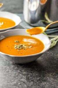 Vegan Creamy Pumpkin Tomato Soup with spoon
