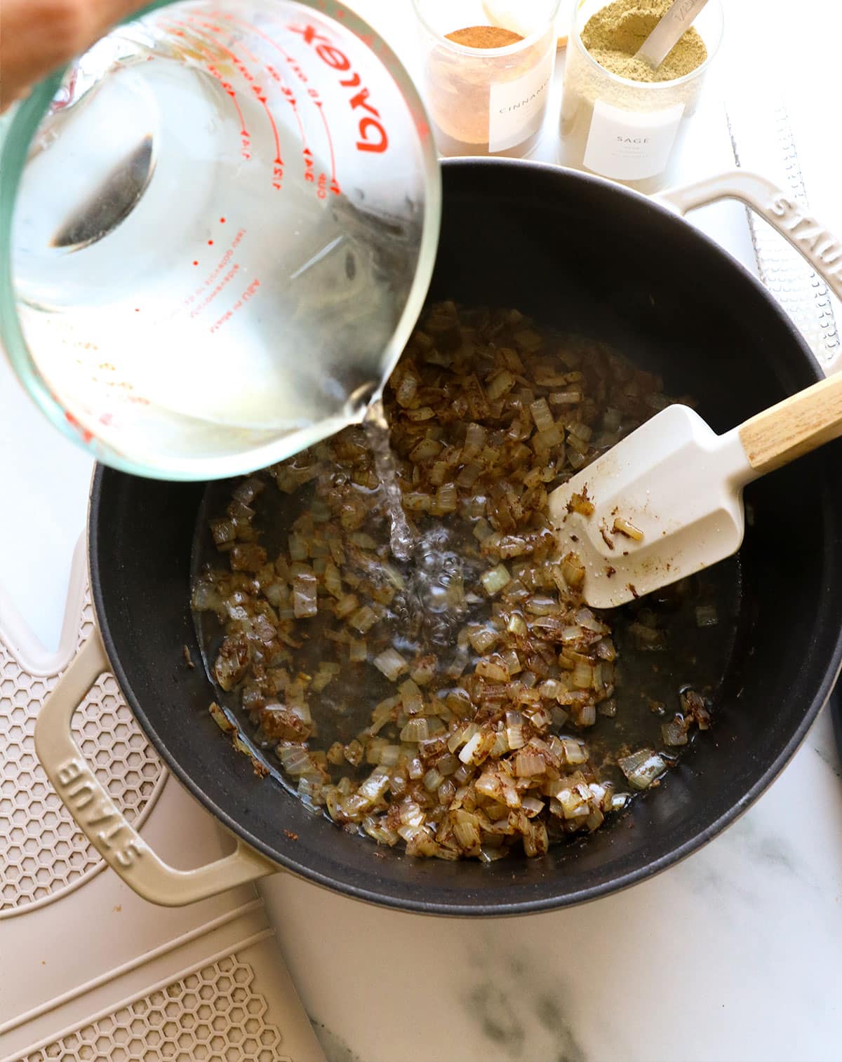 1 cup of water poured into the pot with onions and spices.