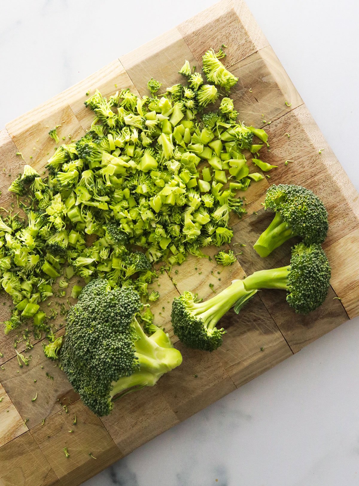 finely chopped broccoli on a cutting board.