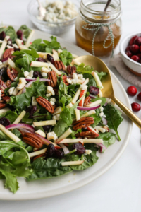 holiday salad topped with pecans and apples.