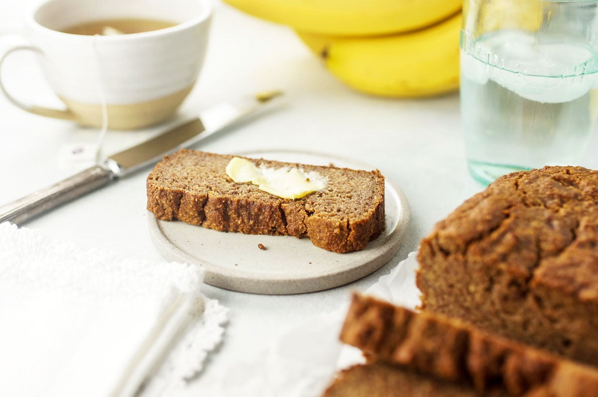 slice of almond flour banana bread with butter on top