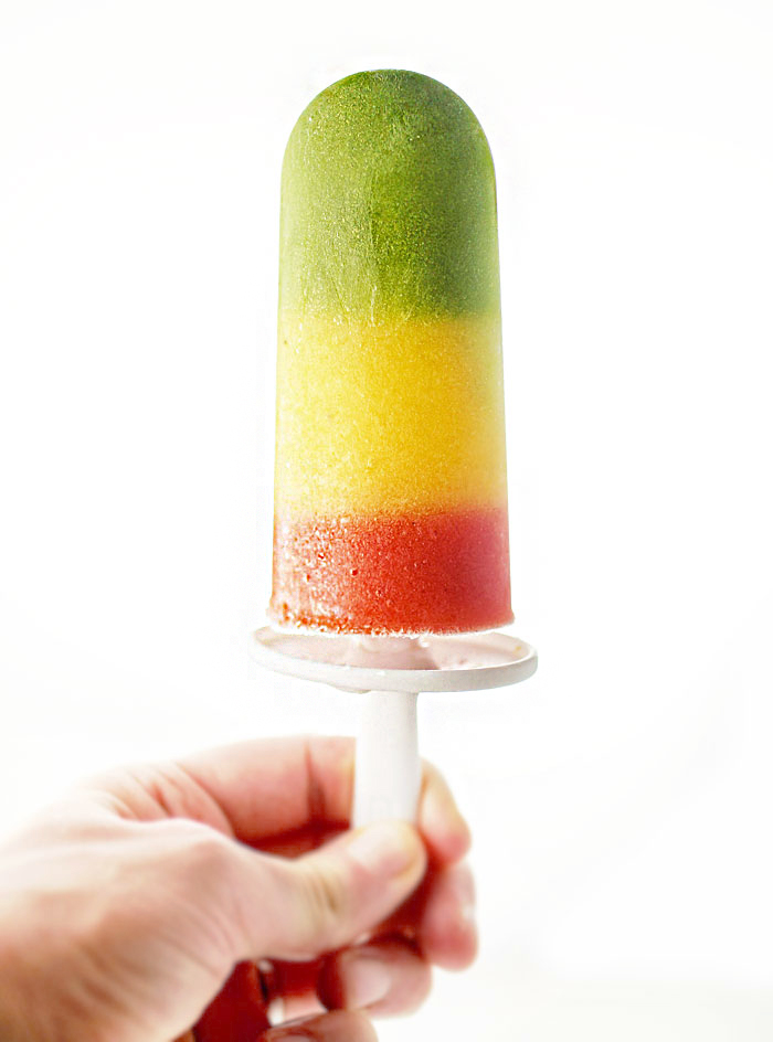 hand holding healthy layered popsicles 