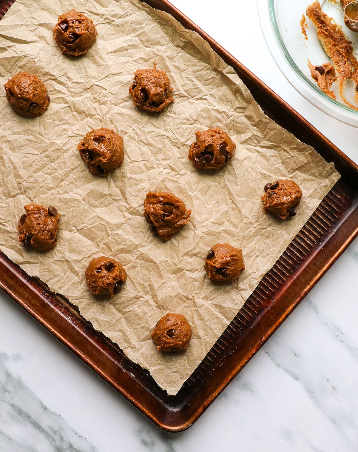 buckwheat cookie dough on a baking sheet with parchment paper.