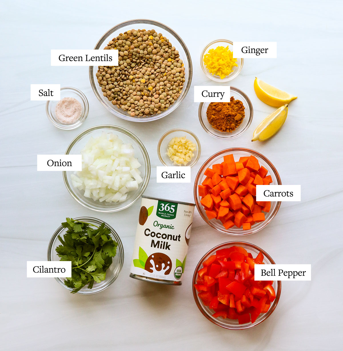 instant pot lentil curry ingredients labeled in glass bowls.
