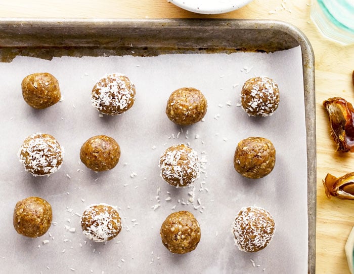 pan of 3-Ingredient Nut-Free Energy Bites with half rolled in coconut flakes