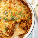 Mexican cauliflower rice casserole with wooden spoon