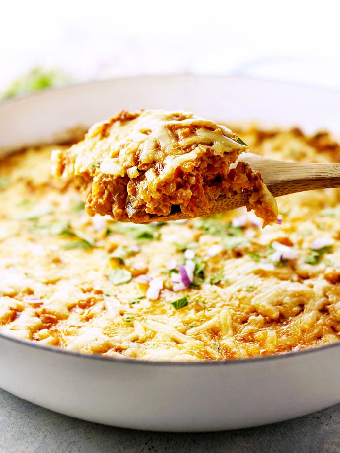 scoop of mexican cauliflower casserole lifted up with a spoon