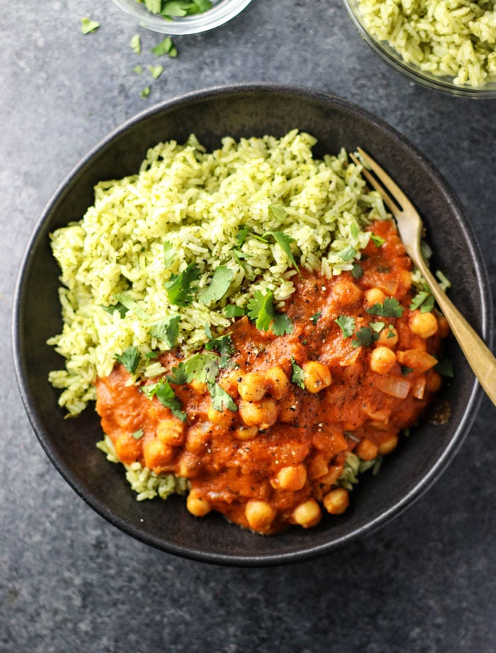 vegan chickpea tikka masala with green rice in a bowl