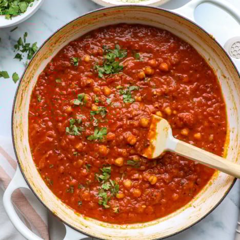 chickpea tikka masala in a white pan with cilantro on top.