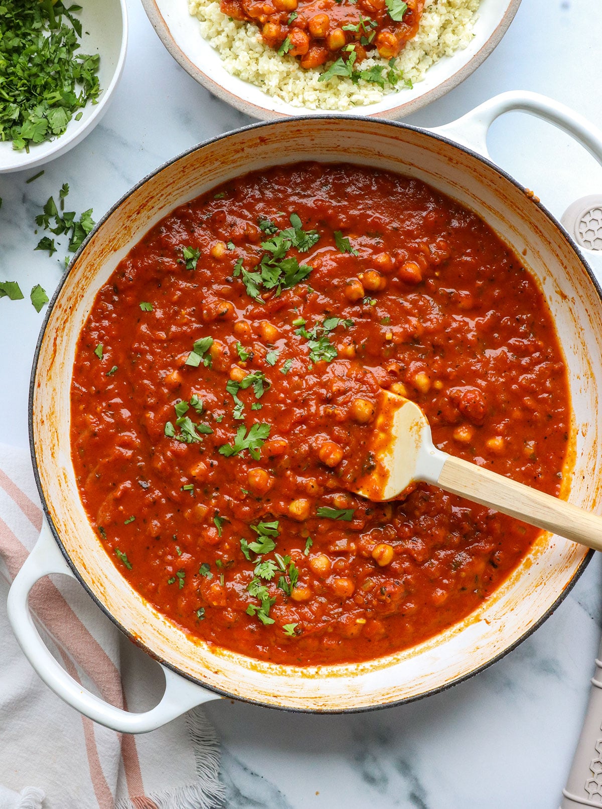 chickpea tikka masala in a white pan with cilantro on top.