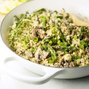 vegan cauliflower rice "risotto" with asparagus and mushrooms in a pan