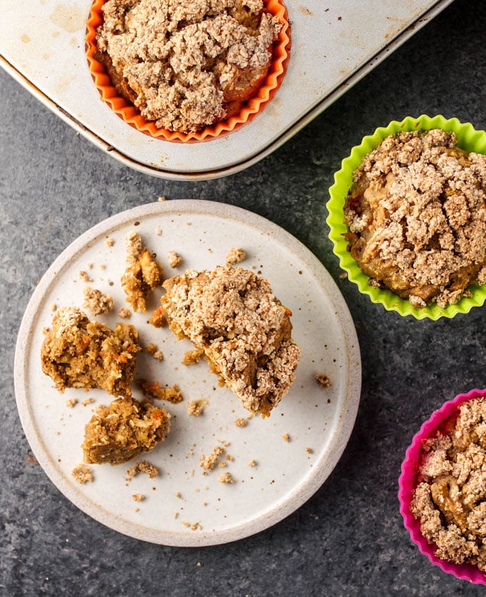 pieces of a gluten-free carrot cake muffin on a plate