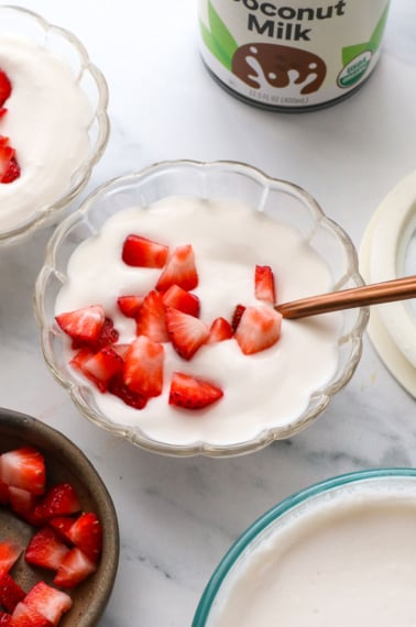 coconut milk yogurt topped with strawberries.