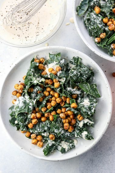 kale Caesar salad in two bowls overhead