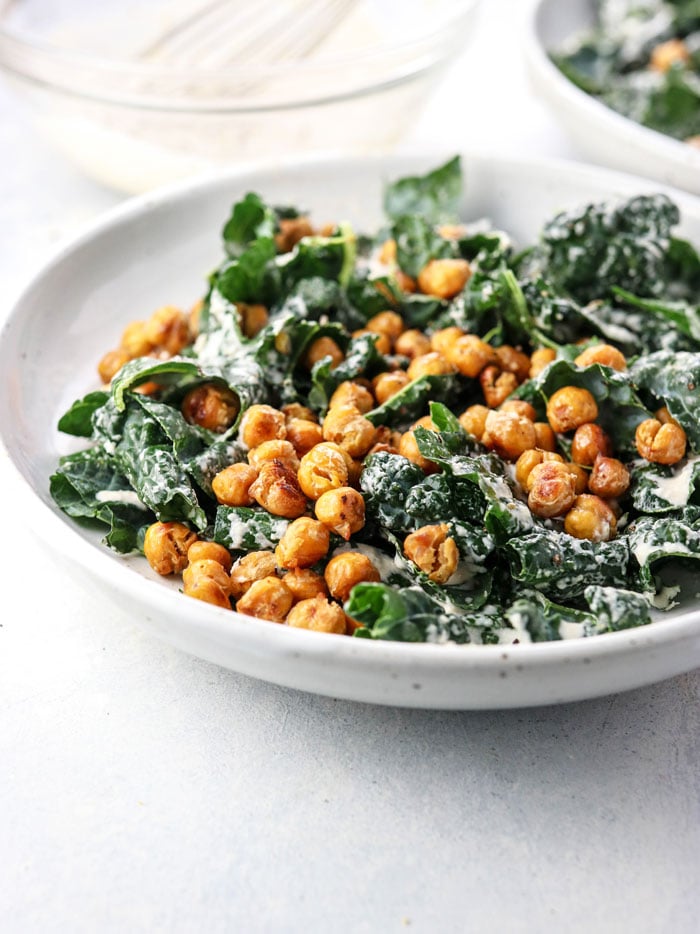 bowl of vegan kale salad with garlic roasted chickpeas