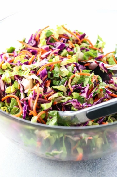 make ahead vegan salad in bowl with tongs