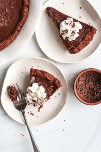 chocolate pie slices on two white plates.