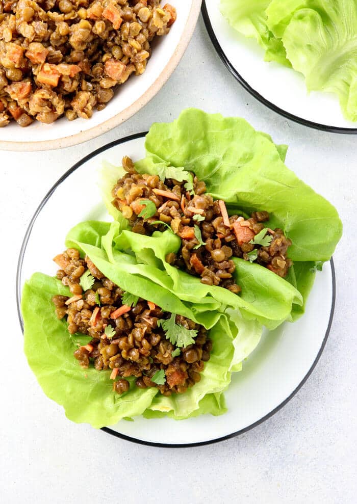 vegan thai lettuce cups on a white plate with butter lettuce leaves